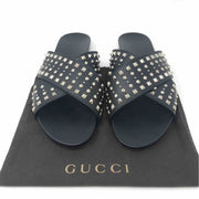 Gucci Vacchetta Austin slides in black leather crisscross design with silver studs.