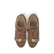 Buscemi buckled calf suede low-top Sneaker in tan. Consists of a 1 inch sole with a round toe and golden buckle. Lace up front with an embossed logo on the side and the tongue. Rubber outsole. Faint signs of wear on the soles and light fading on the suede.  Size: EU 43  Made in Italy. 